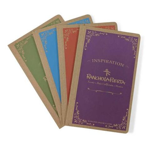 Stack of custom printed journals in various colors with kraft covers and foil stamped designs